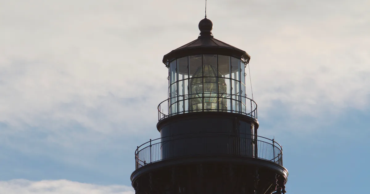 The first-order Fresnel lens is visible in the lantern room of the Bodie Island Lighthouse.
