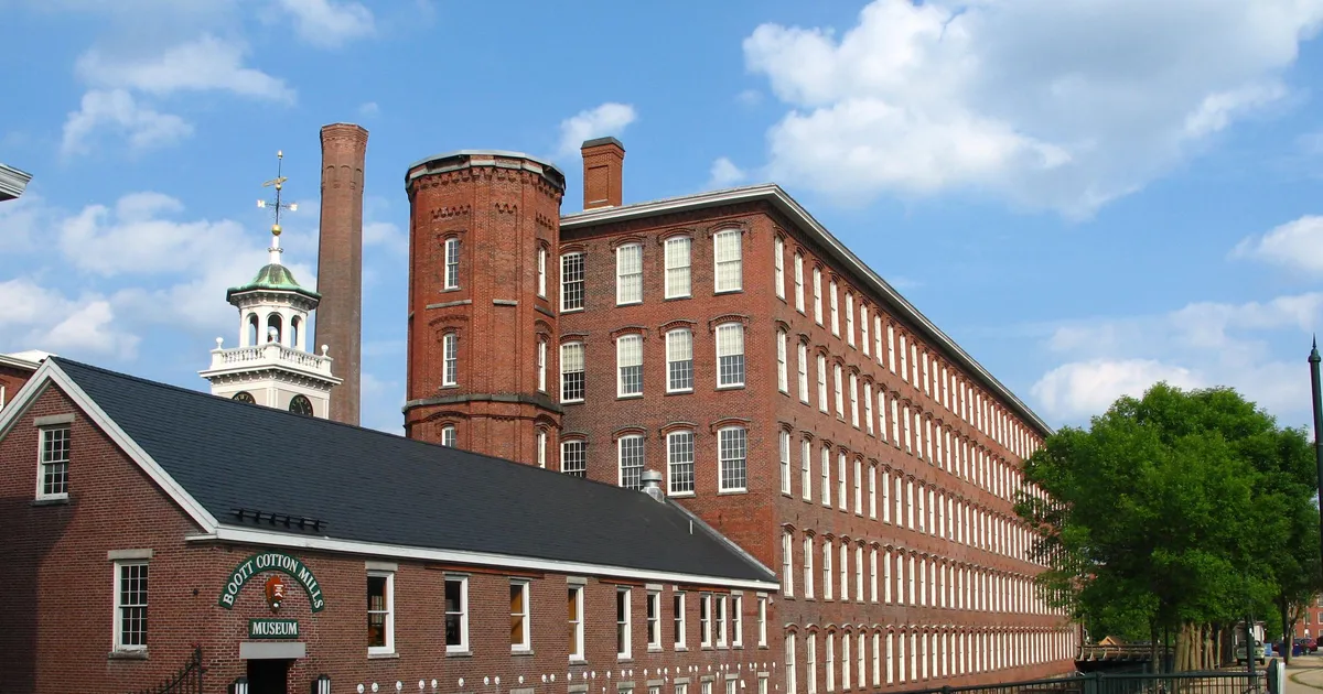 5 story brick factories with a clocktower surrounding a central courtyard
